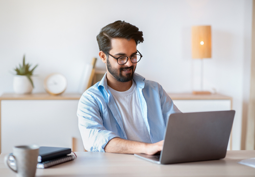 A man looking at a laptop